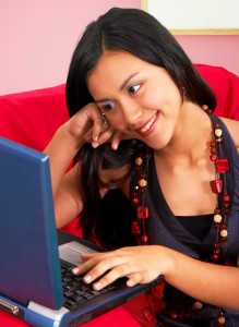 Girl In Her Living Room Using Her Laptop